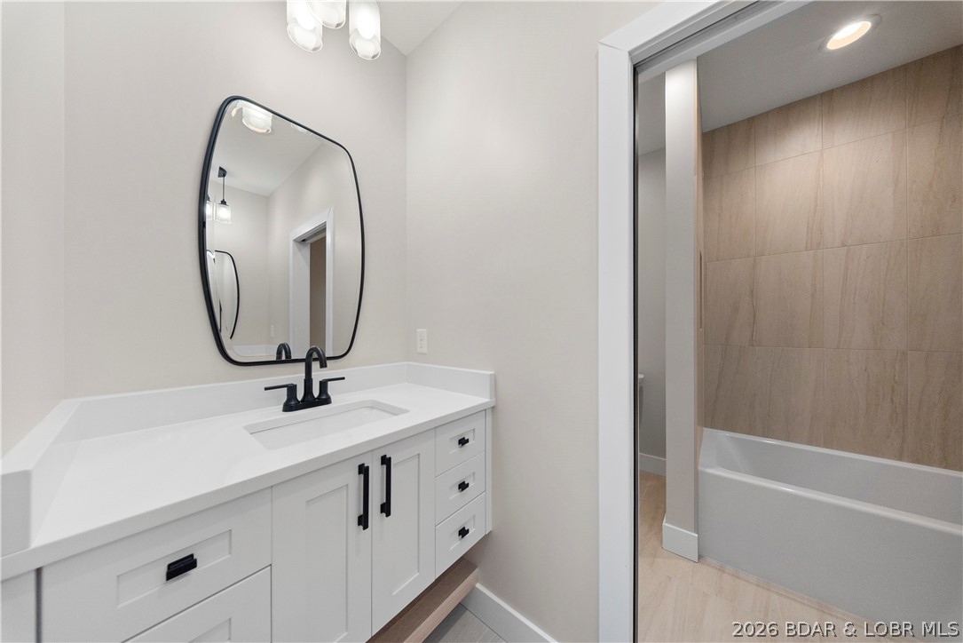 439 Red Bud Road Lake Ozark, MO 65049 - Photo 64 of 98 Tub and shower combination with floor-to-ceiling t