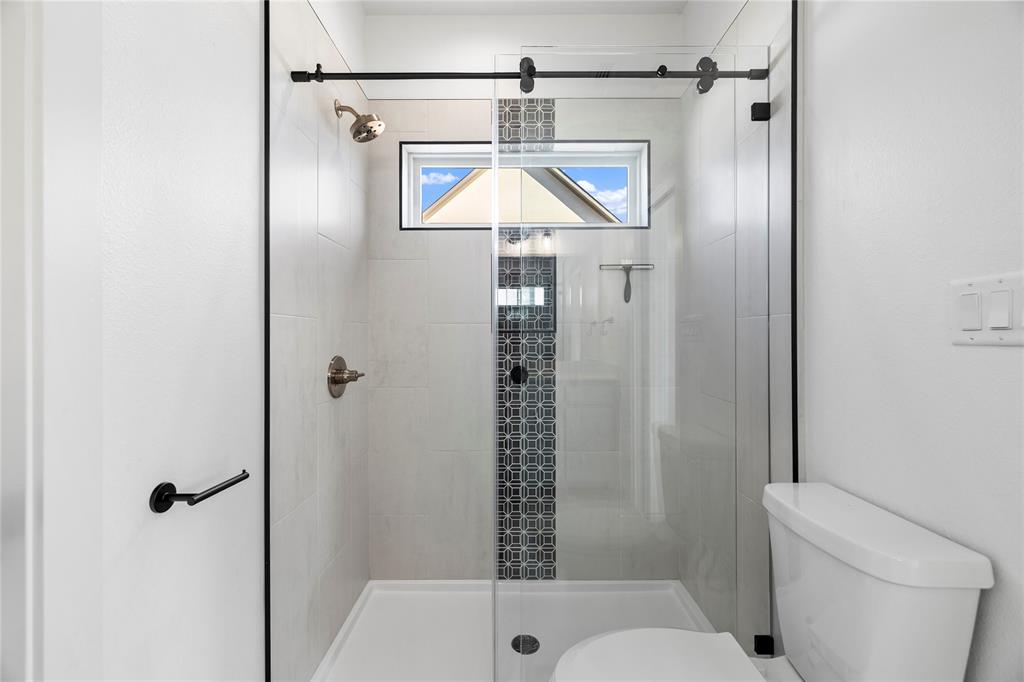 2432 Bellview Circle Tyler, TX 75709 - Photo 36 of 40 a bathroom with a shower a toilet and a shower