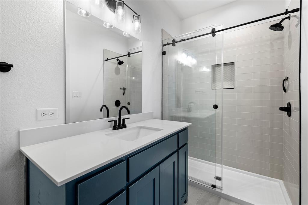 2432 Bellview Circle Tyler, TX 75709 - Photo 39 of 40 a bathroom with a sink vanity mirror and shower