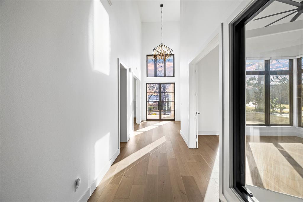 2432 Bellview Circle Tyler, TX 75709 - Photo 9 of 40 a view of a hallway with windows and chandelier