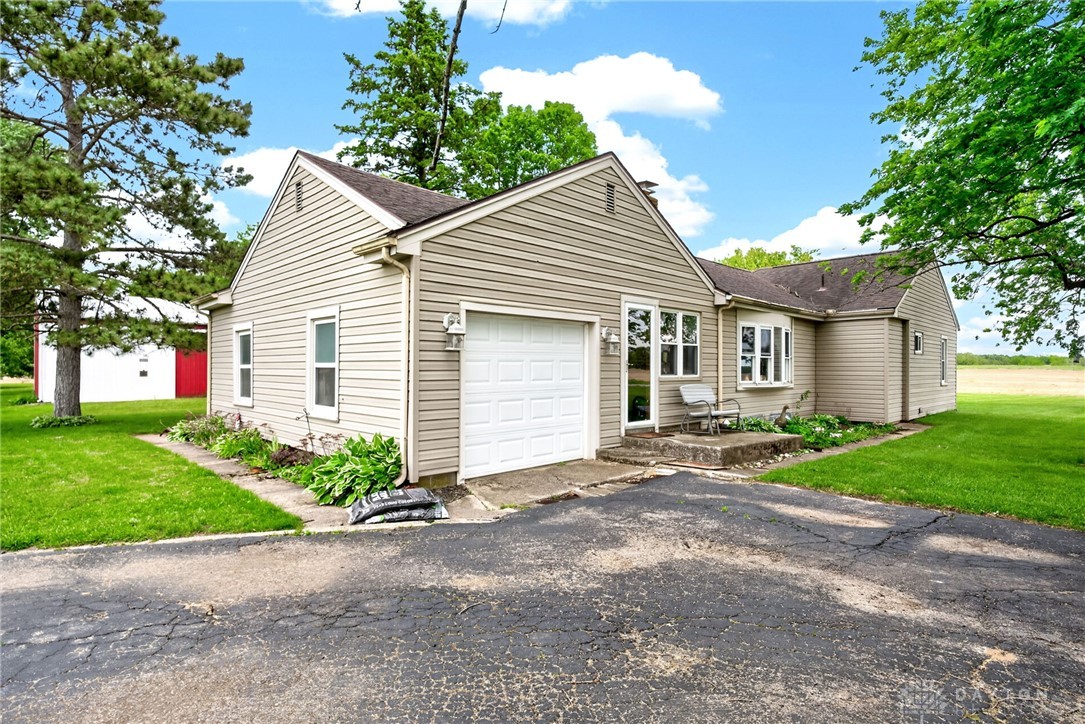 2470 Clark Run Road Xenia, OH 45385 - Photo 49 of 57 This charming home features classic siding and a lush, expansive yard with mature trees.