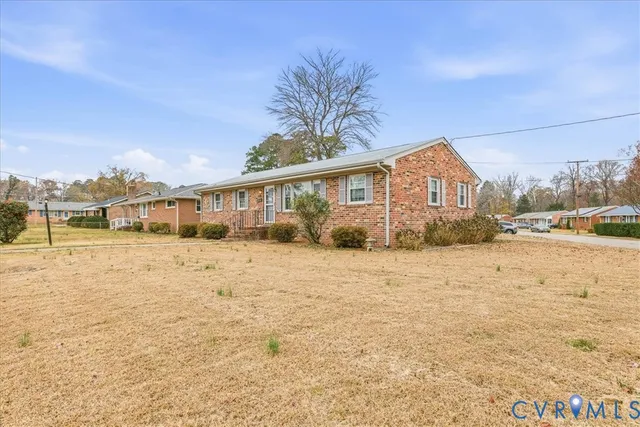 a view of house with yard and ocean