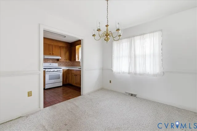 a kitchen with a refrigerator sink stove and cabinets