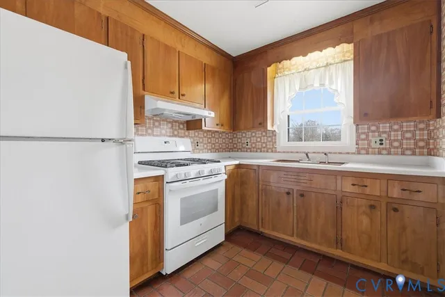 a view of an empty room with window and cabinet
