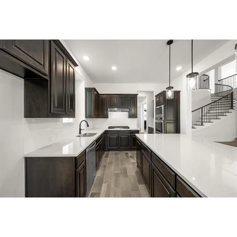 a kitchen with a sink stainless steel appliances and cabinets