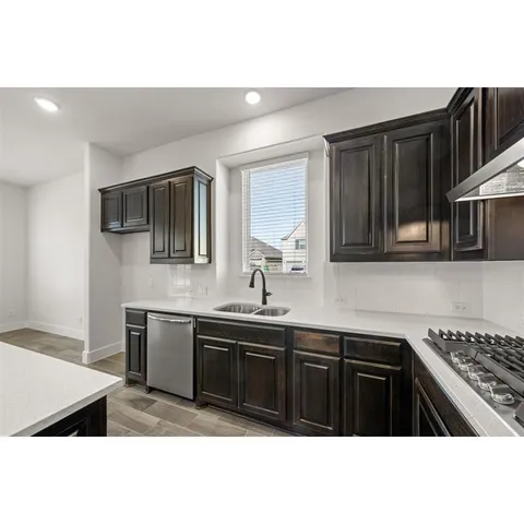 a kitchen with stainless steel appliances a stove and a microwave