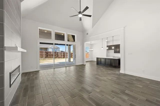 a bathroom with a tub shower sink and mirror