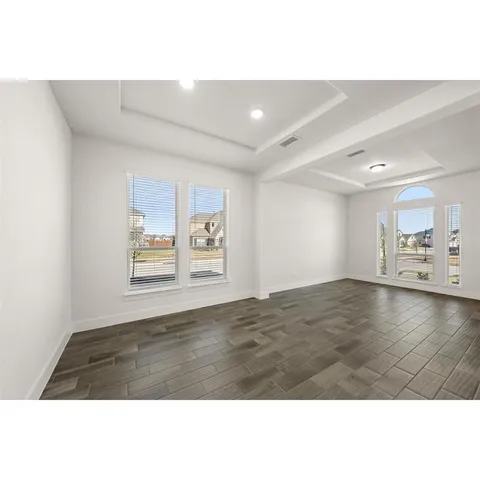 a view of a room window and wooden floor