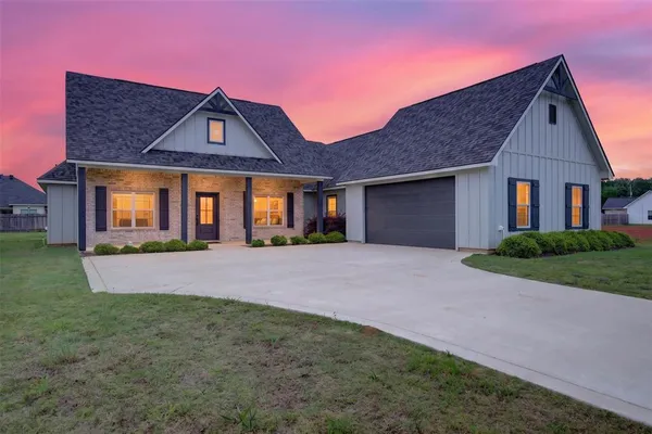 a front view of a house with yard