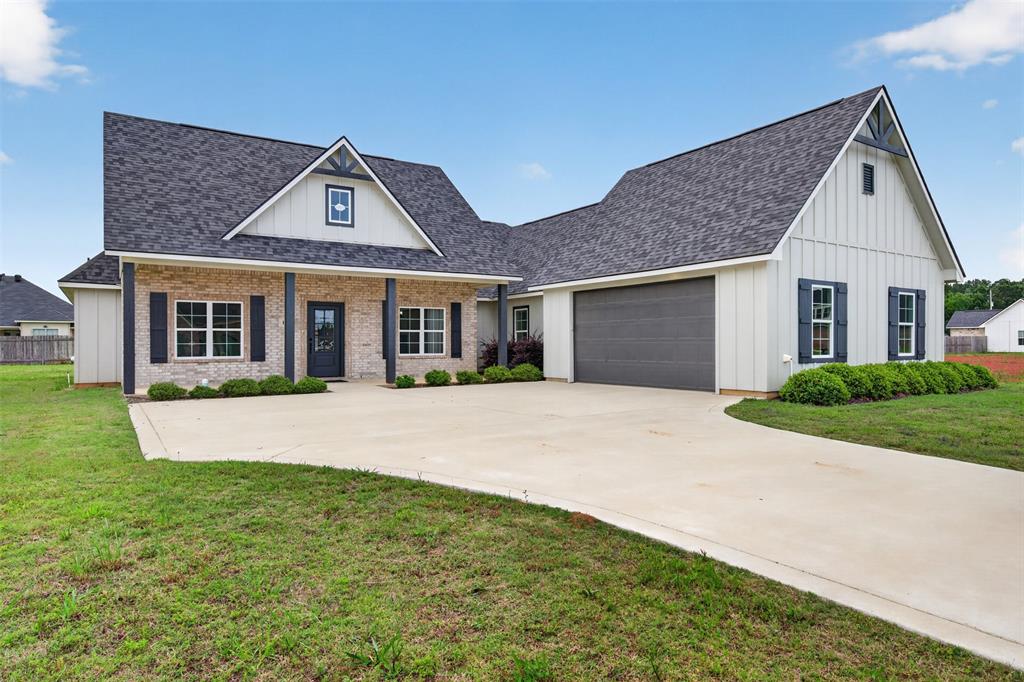 127 Sitka Loop Haughton, LA 71037 - Photo 2 of 29 a front view of a house with a garden