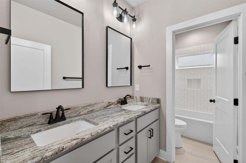 127 Sitka Loop Haughton, LA 71037 - Photo 22 of 29 a bathroom with a granite countertop sink and a mirror