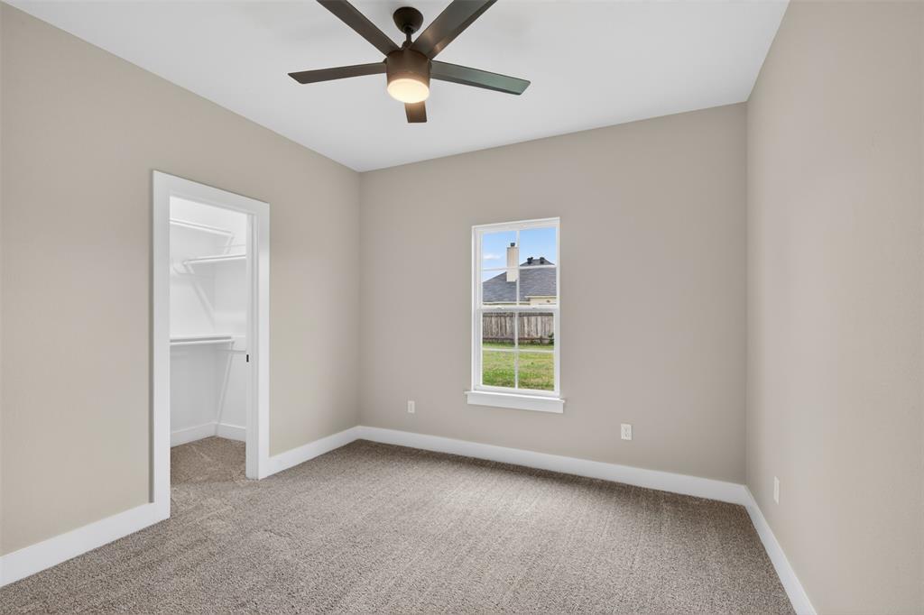 127 Sitka Loop Haughton, LA 71037 - Photo 24 of 29 an empty room with a window and a fan