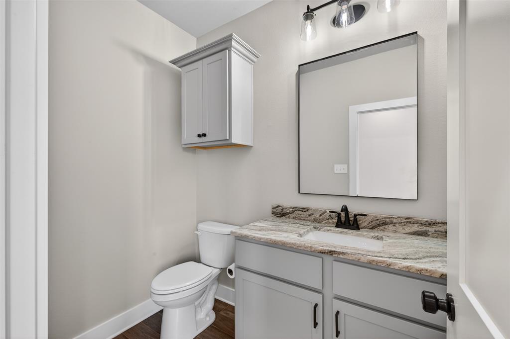 127 Sitka Loop Haughton, LA 71037 - Photo 25 of 29 a bathroom with a granite countertop toilet sink and mirror