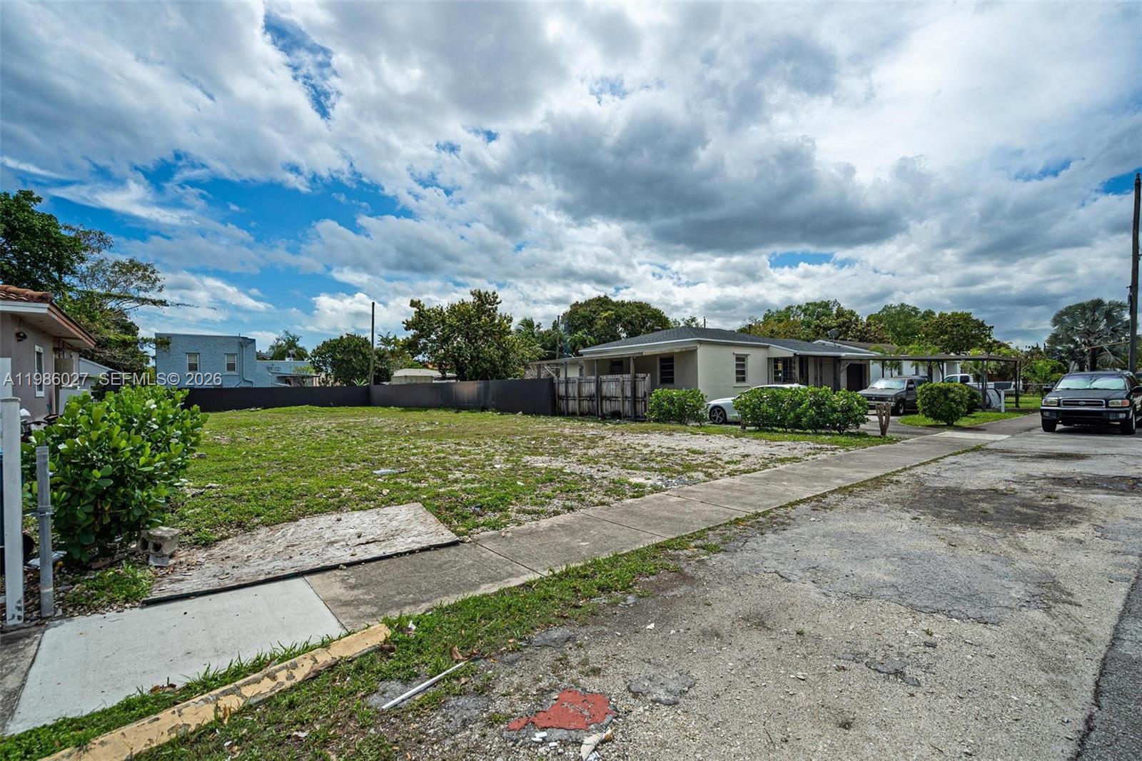 3056 Southwest 13th Street Miami, FL 33145 - Photo 2 of 11 a view of a house with a big yard plants and large trees