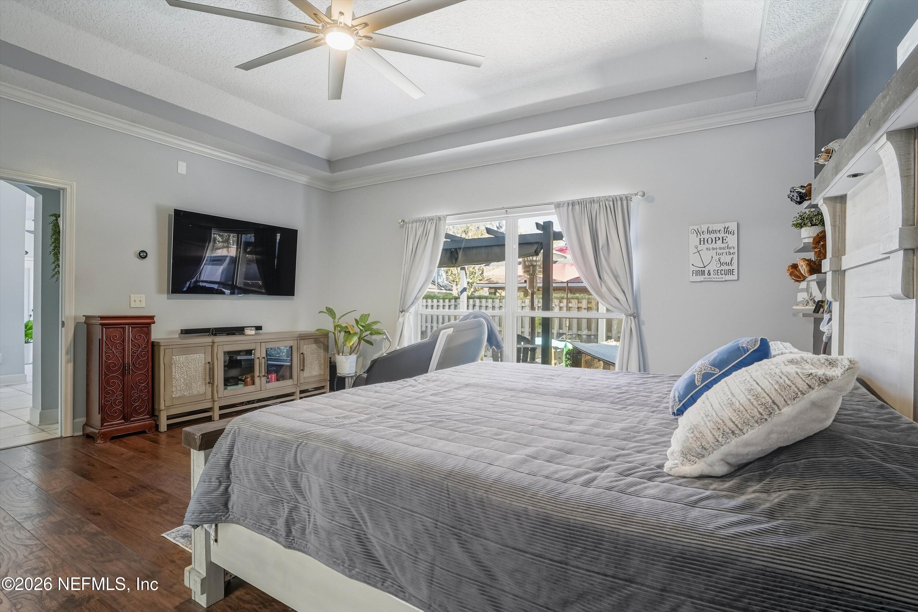 2918 Grande Oaks Way Fleming Island, FL 32003 - Photo 26 of 54 a bedroom with a bed and a flat screen tv