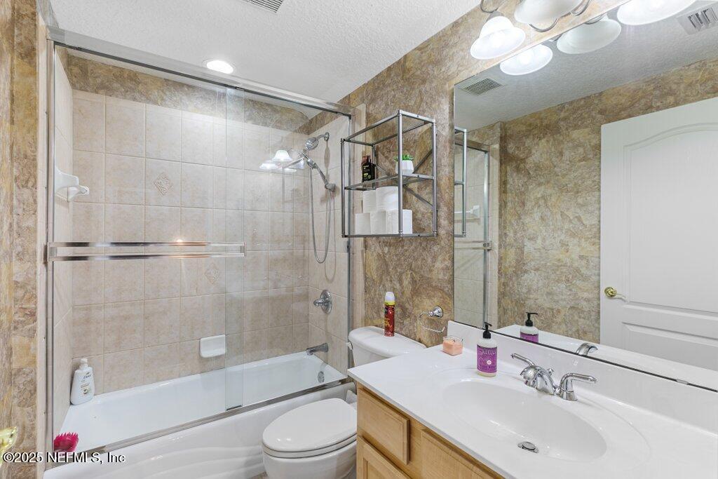 2918 Grande Oaks Way Fleming Island, FL 32003 - Photo 40 of 54 a bathroom with a sink a toilet and shower