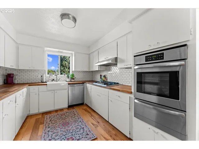 a kitchen with a stove microwave and cabinets