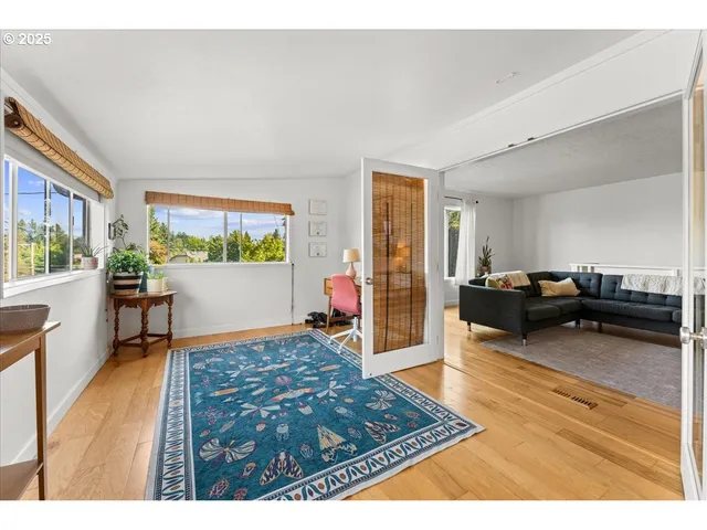 a living room with furniture and a wooden floor
