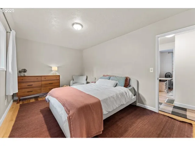 a bedroom with a bed and a night stand