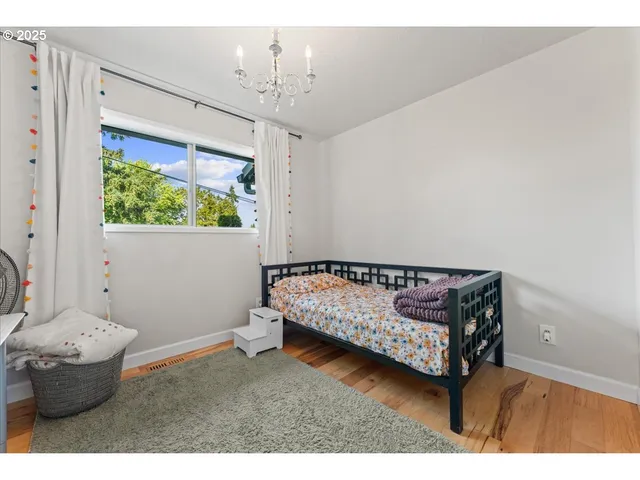 a bedroom with furniture and a chandelier