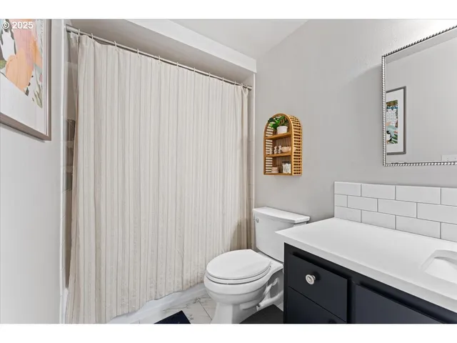 a bathroom with a toilet a sink a vanity and mirror