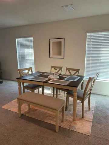 a dining room with furniture and window