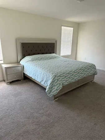 a bedroom with a bed and a couch