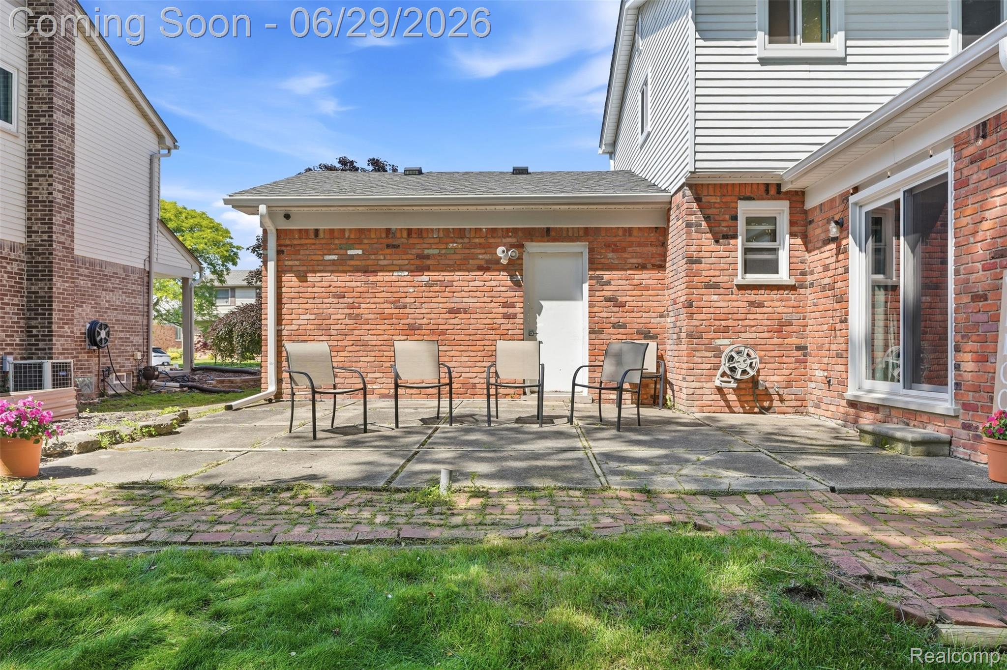 45179 Rudgate Road Canton, MI 48188 - Photo 31 of 48 Brick exterior with white siding accents and a concrete patio