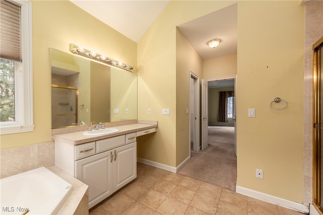 455 Old Reservoir Road Berea, OH 44017 - Photo 18 of 49 Bathroom with tile patterned flooring, vanity, vaulted ceiling, and independent shower and bath