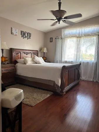 a spacious bedroom with a bed and window