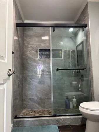 a bathroom with a shower and toilet