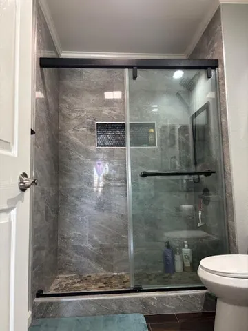 a bathroom with a shower and toilet