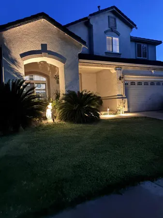 a front view of a house with a garden