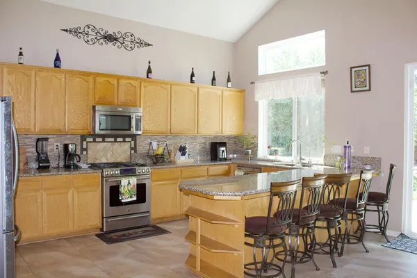 a large kitchen with a table and chairs
