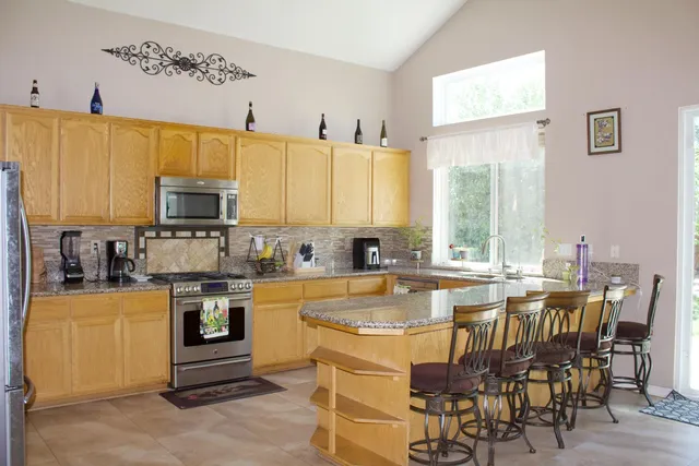 a large kitchen with a table and chairs