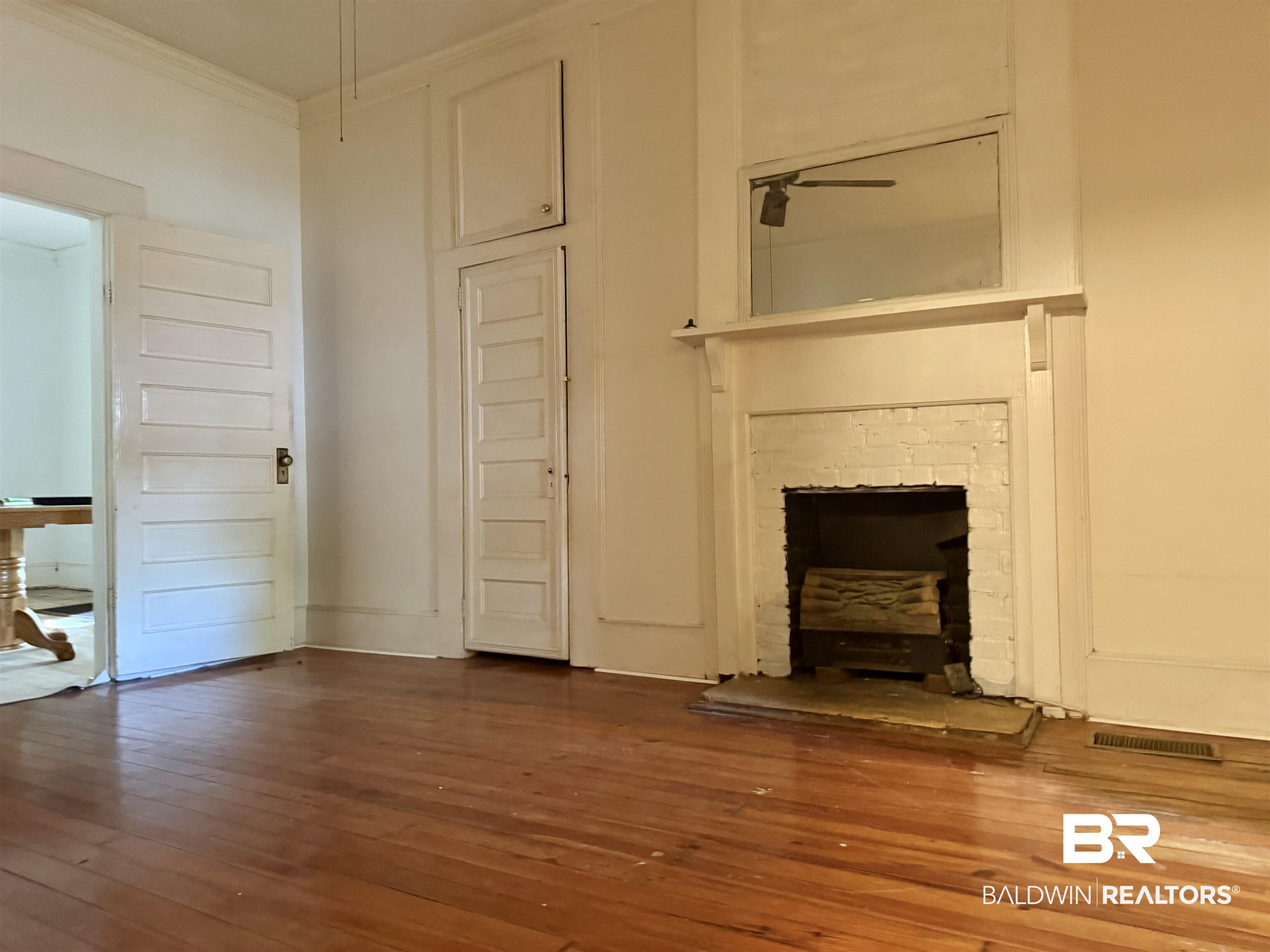 610 Alco Drive Brewton, AL 36426 - Photo 16 of 18 Unfurnished living room with crown molding and wood-type flooring