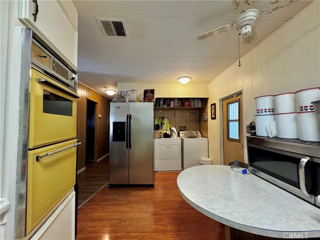 a kitchen with refrigerator and windows