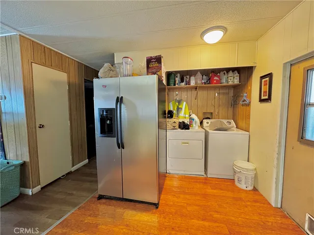 a bathroom with a refrigerator sink and mirror