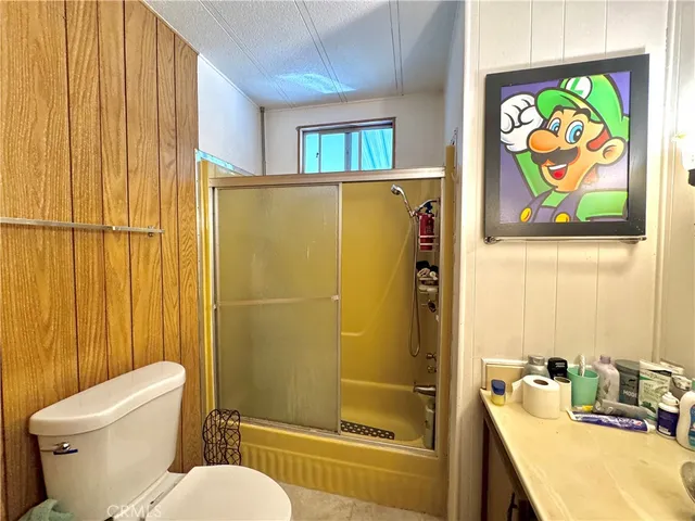a bathroom with a sink mirror vanity and toilet