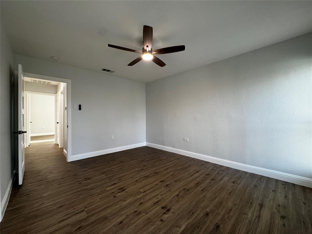 2909 Alexander Avenue Waco, TX 76708 - Photo 15 of 27 Empty room featuring dark wood-type flooring and ceiling fan