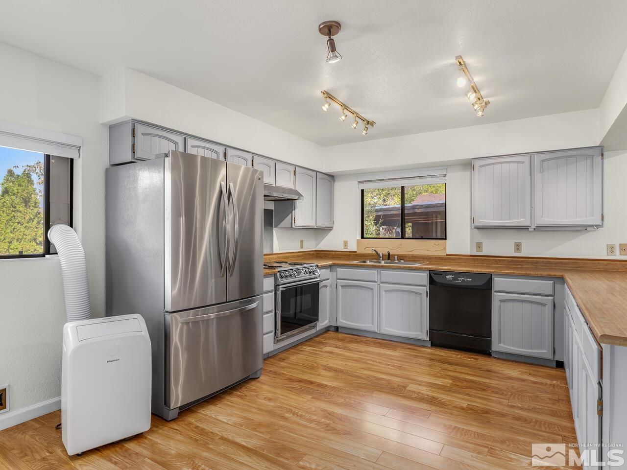665 College Drive Reno, NV 89503 - Photo 12 of 25 a kitchen with granite countertop a refrigerator stove top oven and sink