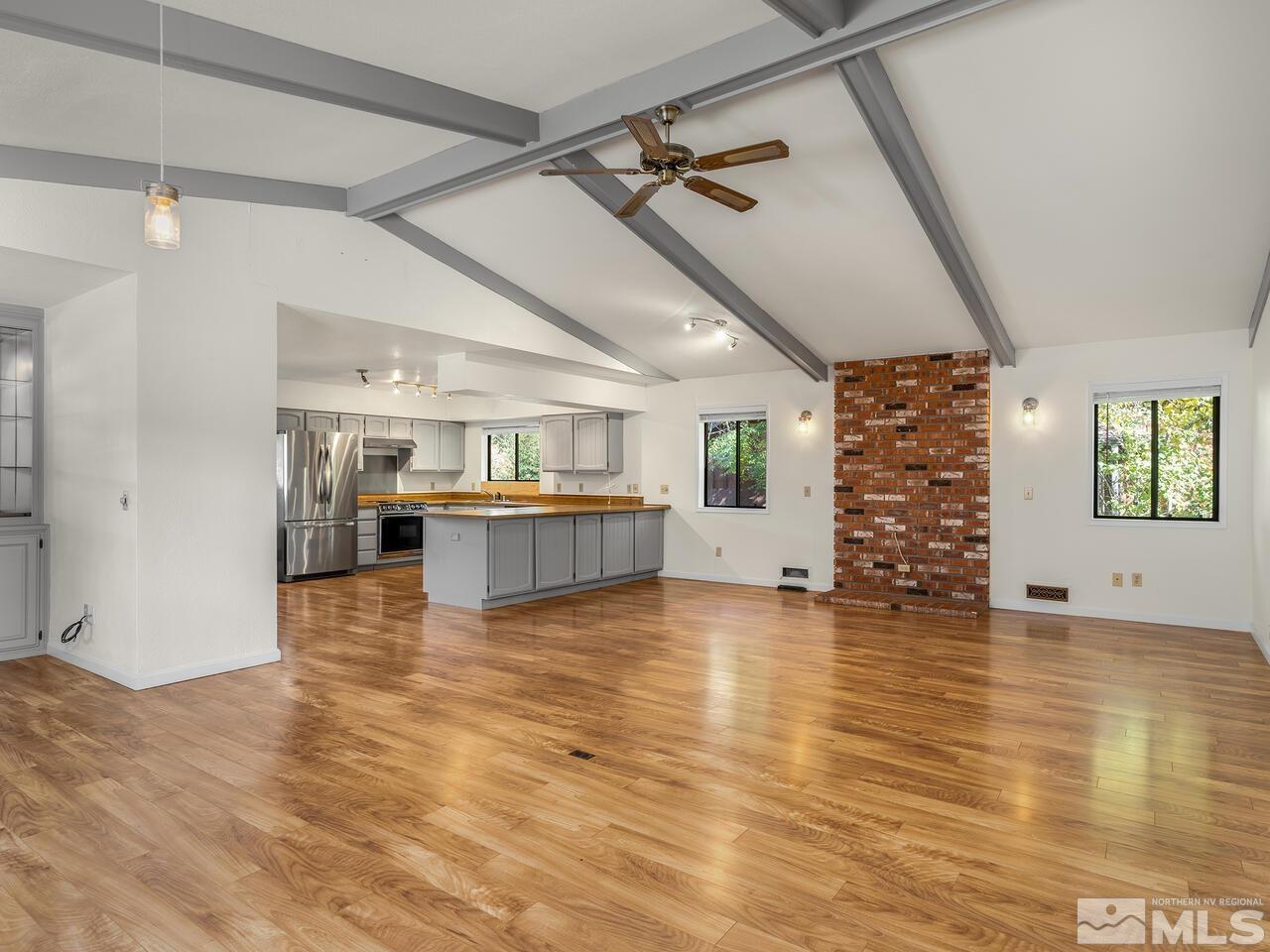 665 College Drive Reno, NV 89503 - Photo 3 of 25 a view of an empty room with a window and wooden floor