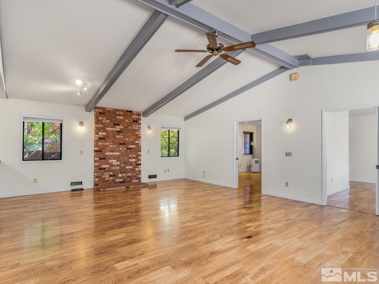 665 College Drive Reno, NV 89503 - Photo 7 of 25 an empty room with wooden floor and windows