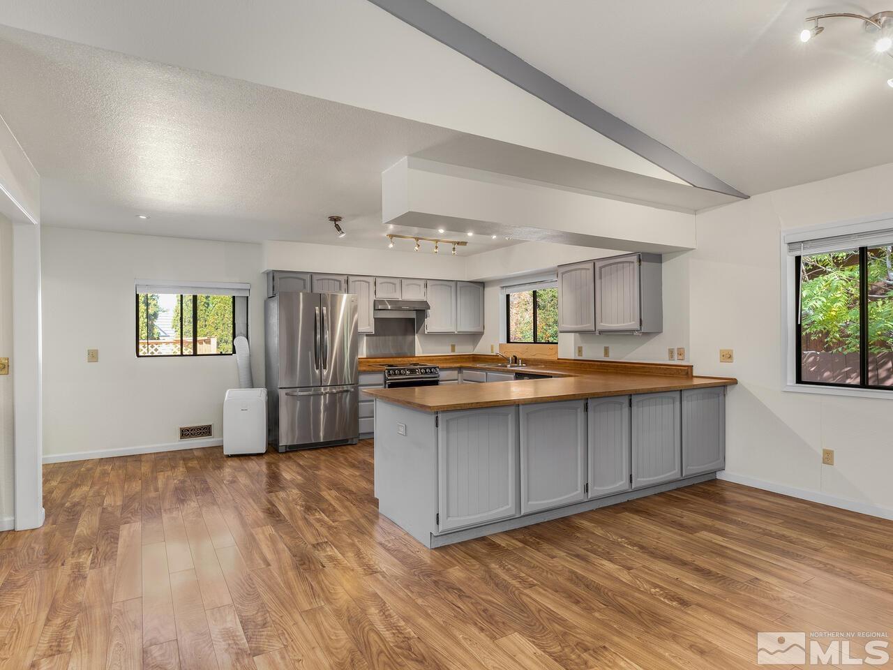 665 College Drive Reno, NV 89503 - Photo 9 of 25 a kitchen with stainless steel appliances granite countertop a sink and cabinets