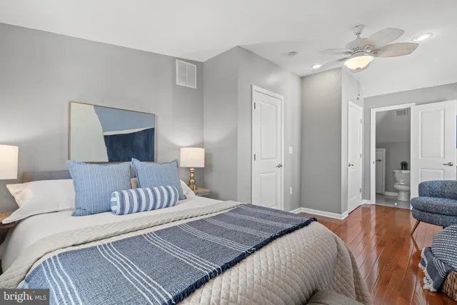 a bedroom with a bed and ceiling fan