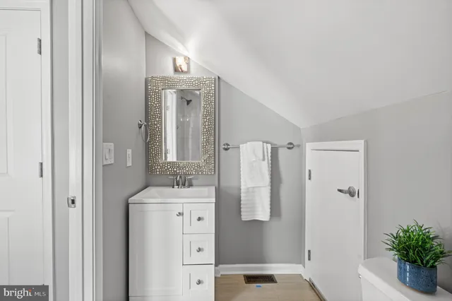 a bathroom with a shower sink and mirror
