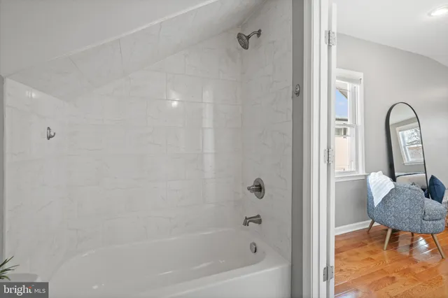 a bathroom with a bathtub and a shower