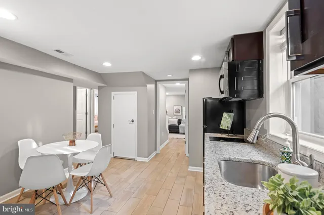 a kitchen with stainless steel appliances granite countertop a sink and a refrigerator