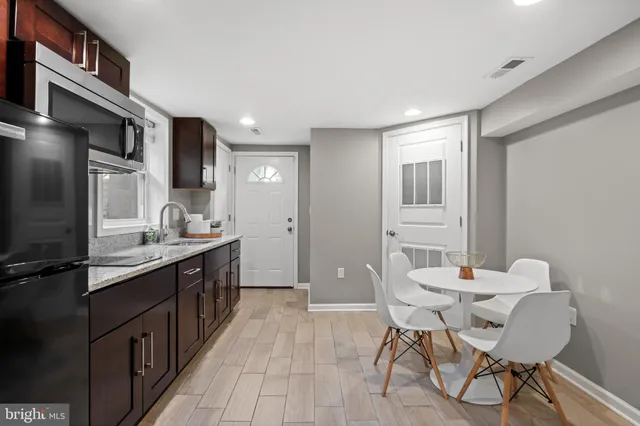 a kitchen with stainless steel appliances kitchen island granite countertop a sink and cabinets