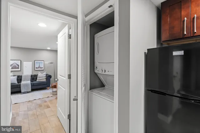 a view of a hallway with couch and cabinets